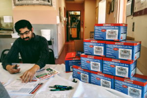 YSAPC coordinator, A.J. Sandoval sits at the HMS Silver City Senior Center with the complimentary lock boxes distributed to seniors who took a pledge to secure their medications.